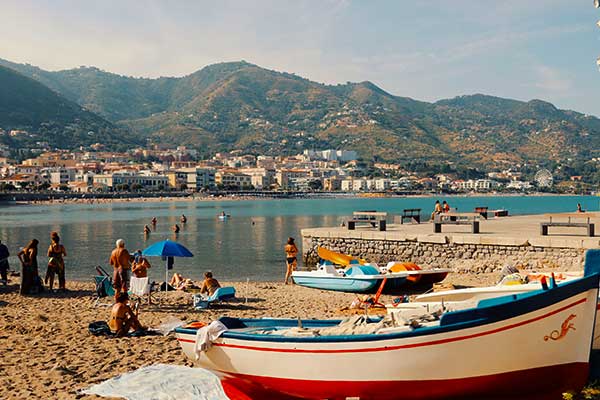 Pebble beach and clear Mediterranean water along the Amalfi Coast in Italy