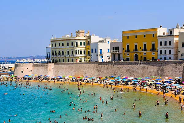 Spiaggia Grande in Positano surrounded by colourful buildings and steep cliffs