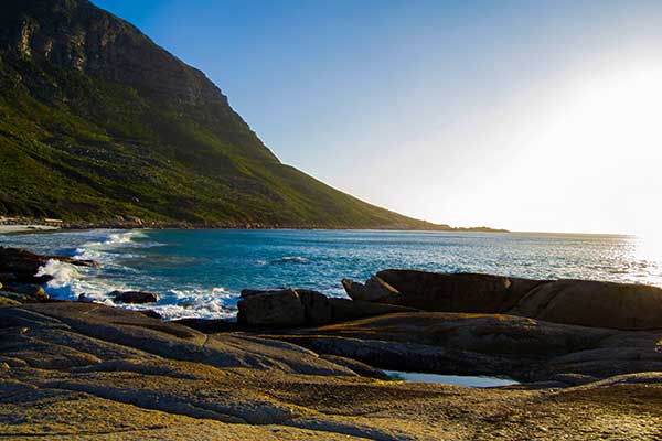 Llandudno Beach near Cape Town surrounded by granite rocks and green coastal vegetation