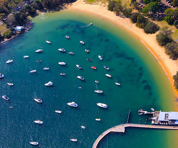 Balmoral Beach Sydney Harbour with calm water and grassy reserve