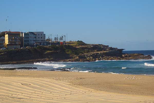 Maroubra Beach Sydney with surfers and wide sandy shoreline