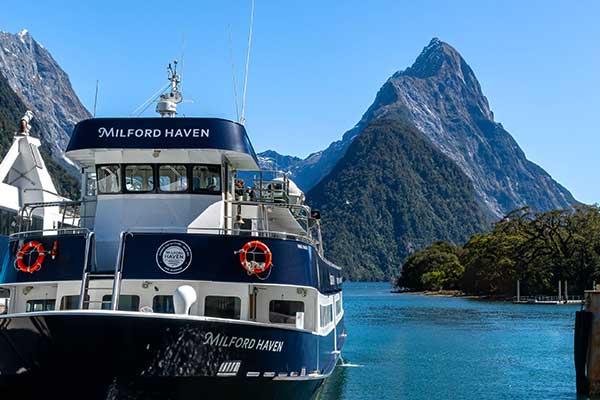 Large sightseeing cruise boat sailing through Milford Sound
